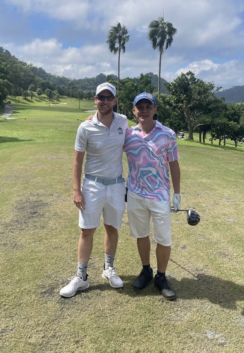 Two IGST members on a palm-lined fairway