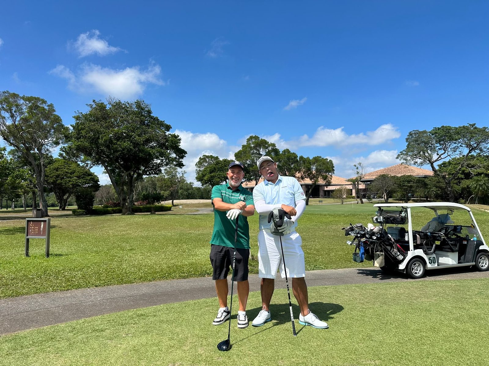 Two IGST members with a golf cart